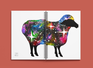 Cosmic Sheep Wellness Journal. Front and back of cover showing the front and back of a sheep with wool made of stars and cosmic colours.